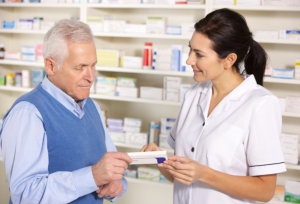 pharmacist serving senior man